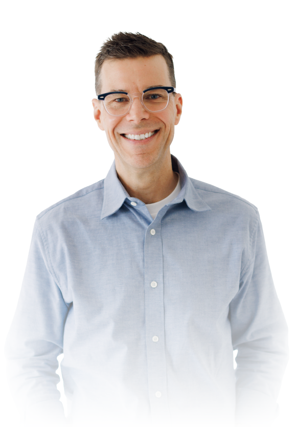 Smiling person in glasses wearing a light blue button-up shirt on a white background
