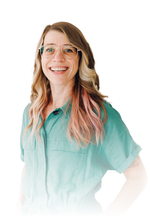 Smiling person in glasses wearing a teal shirt, standing against a white background