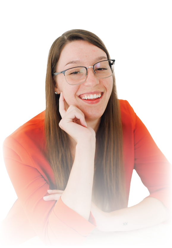 Smiling person with glasses and long brown hair, resting chin on hand against a white background
