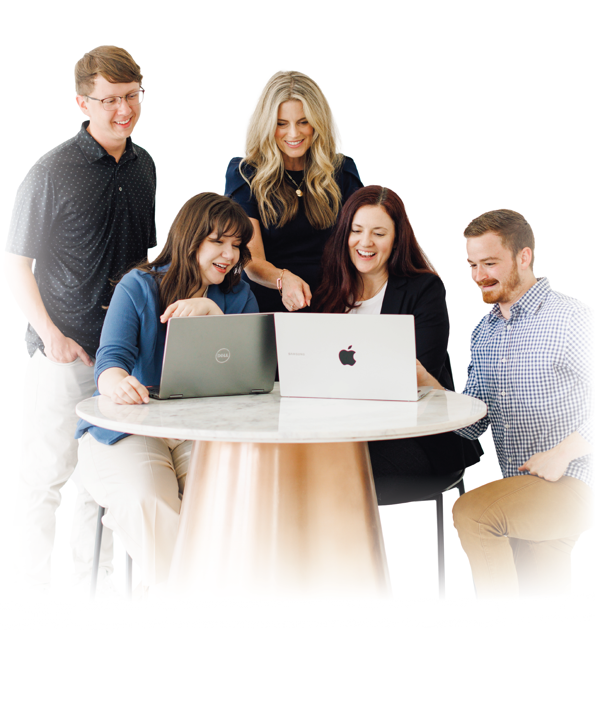 Five people gathered around a table with laptops in a bright office, collaborating and smiling.