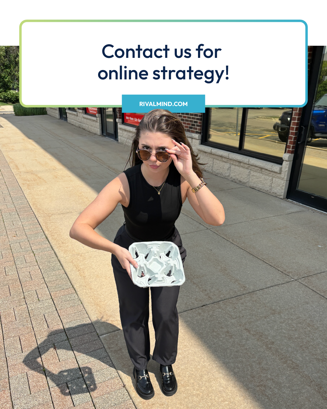 Person standing on a sidewalk holding a clear bag, with a “Contact us for online strategy!” sign above.