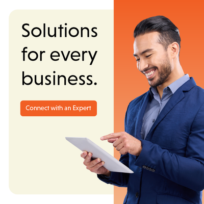 Businessman in blue suit using a tablet beside text: “Solutions for every business” and “Connect with an Expert.”