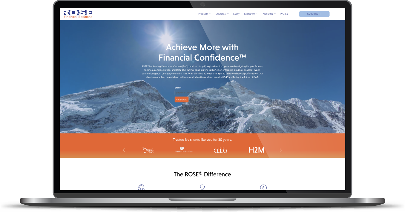 Laptop displaying a financial website with mountain hero image and orange navigation bar