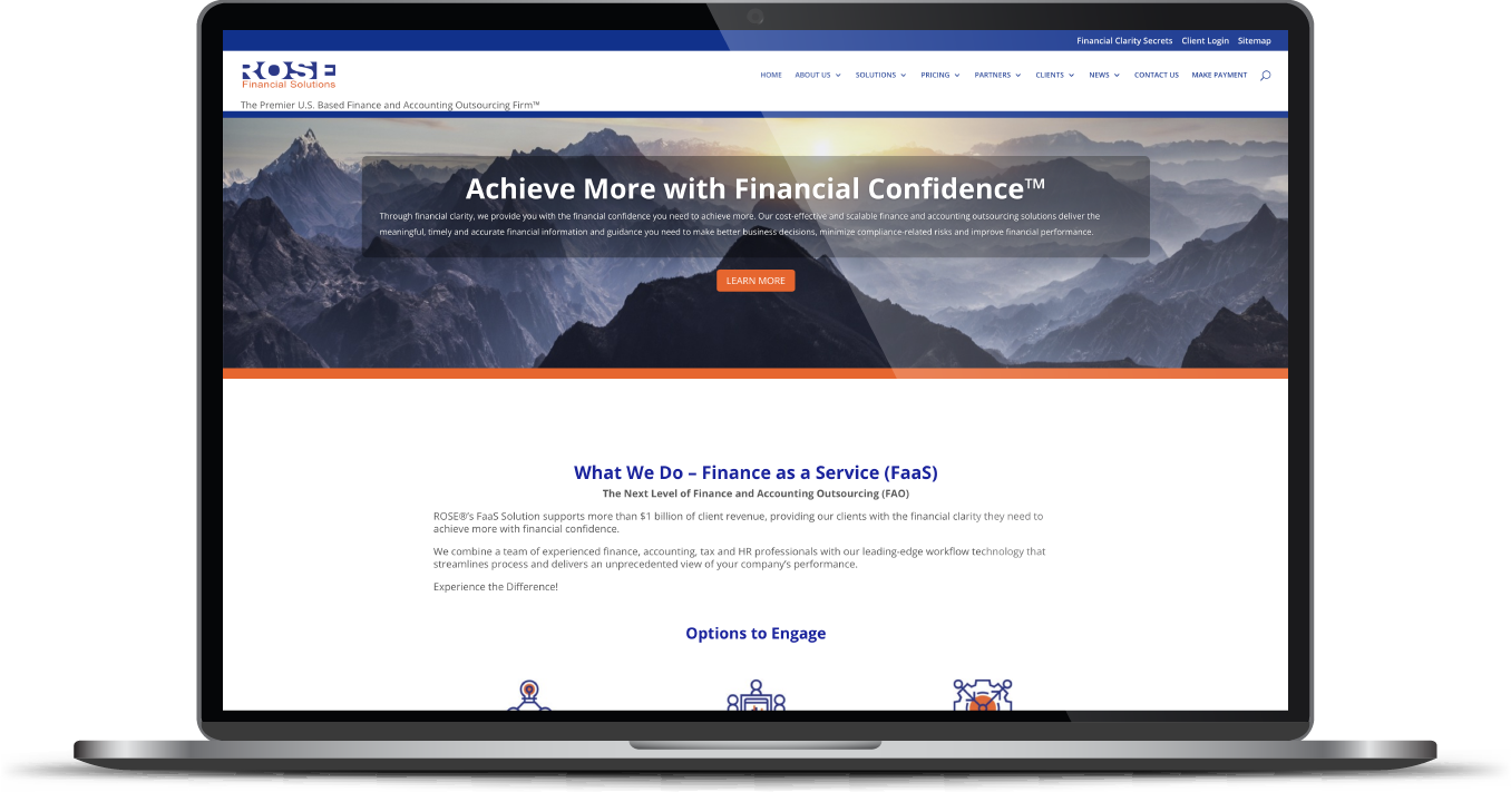 Laptop displaying a conference website with a mountain banner and centered event details.