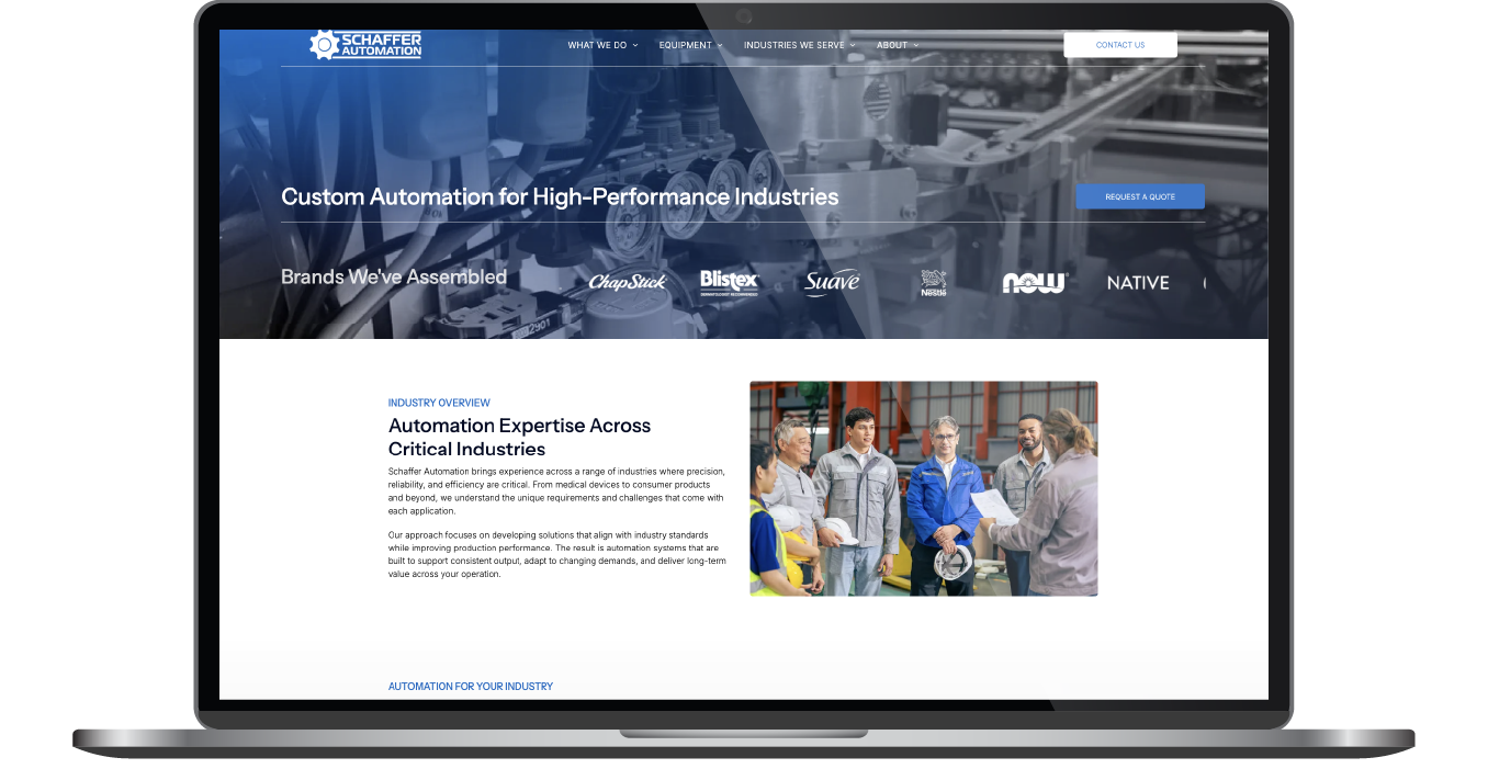 Laptop displaying a blue website homepage with a grid of content tiles and navigation bar