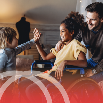 Child and smiling adult sharing a high-five in a warm home setting