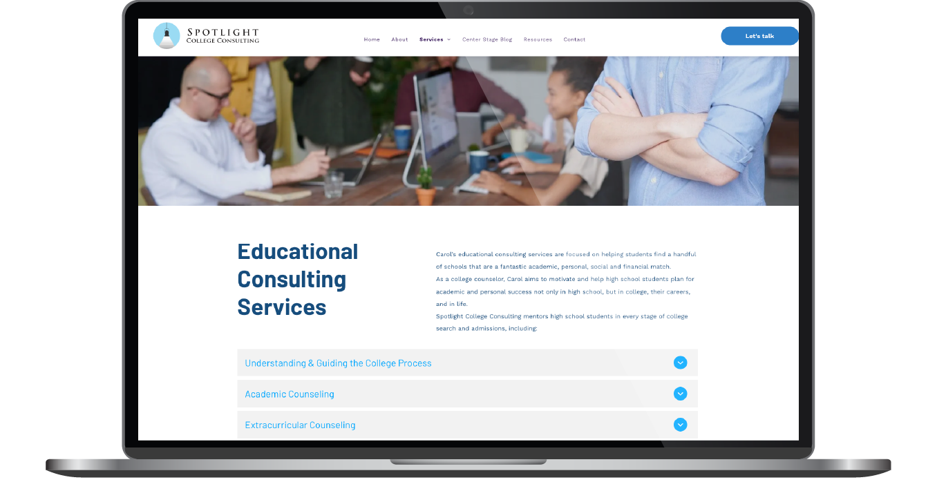 Laptop displaying an educational consulting services website with a meeting photo and blue navigation tabs
