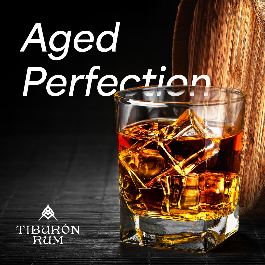 Aged Perfection rum ad with two glasses of amber whiskey and ice on a dark background.