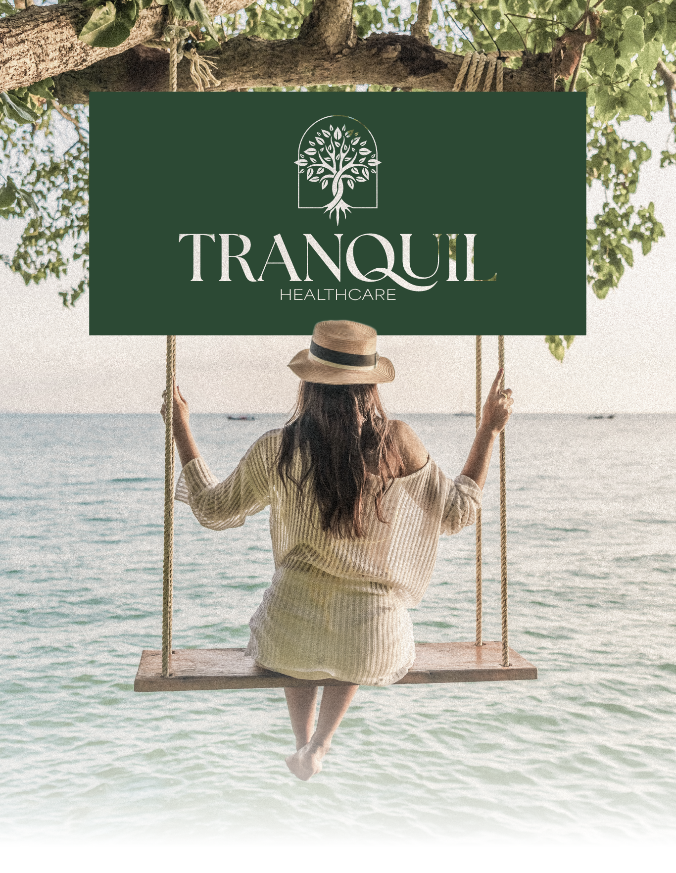 Woman on a beach swing holding a green sign reading “TRANQUIL” over calm water.