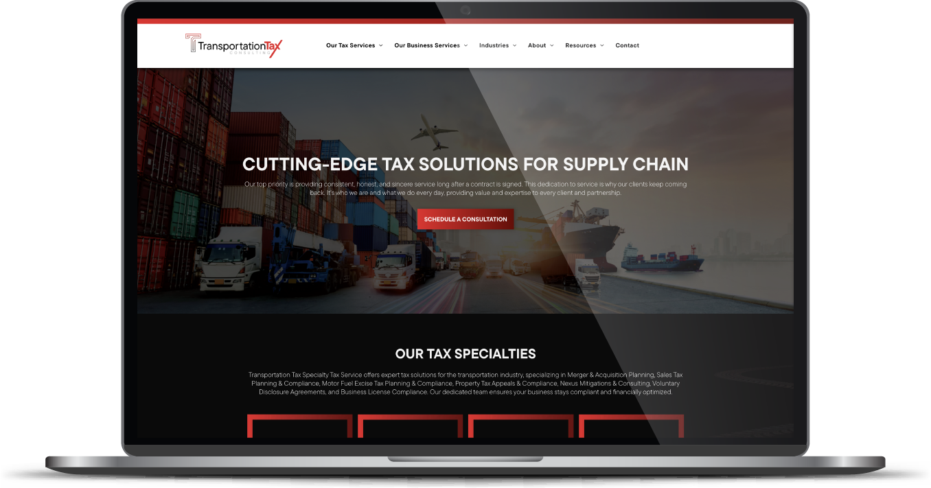 Laptop displaying a logistics company homepage with a truck background and bold red-and-white text.