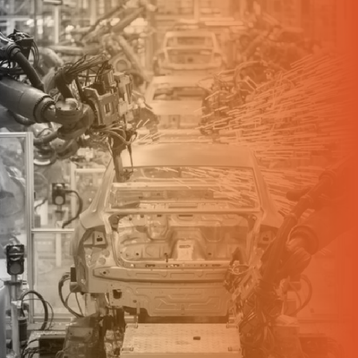 Automated car assembly line with robotic arms and unfinished vehicles, tinted orange on the right