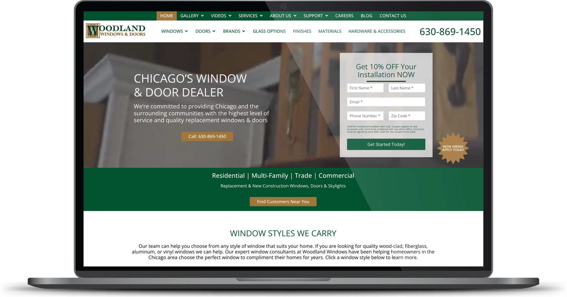 Laptop displaying a green-themed website with a search box and login form on the homepage