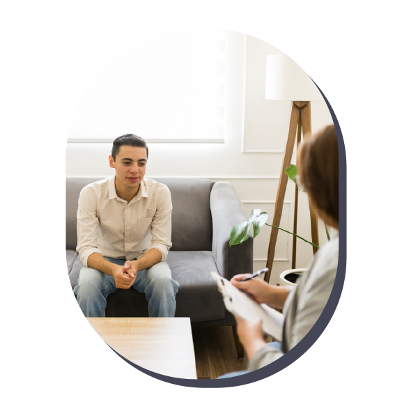 Counseling session with a seated man and therapist in a bright office