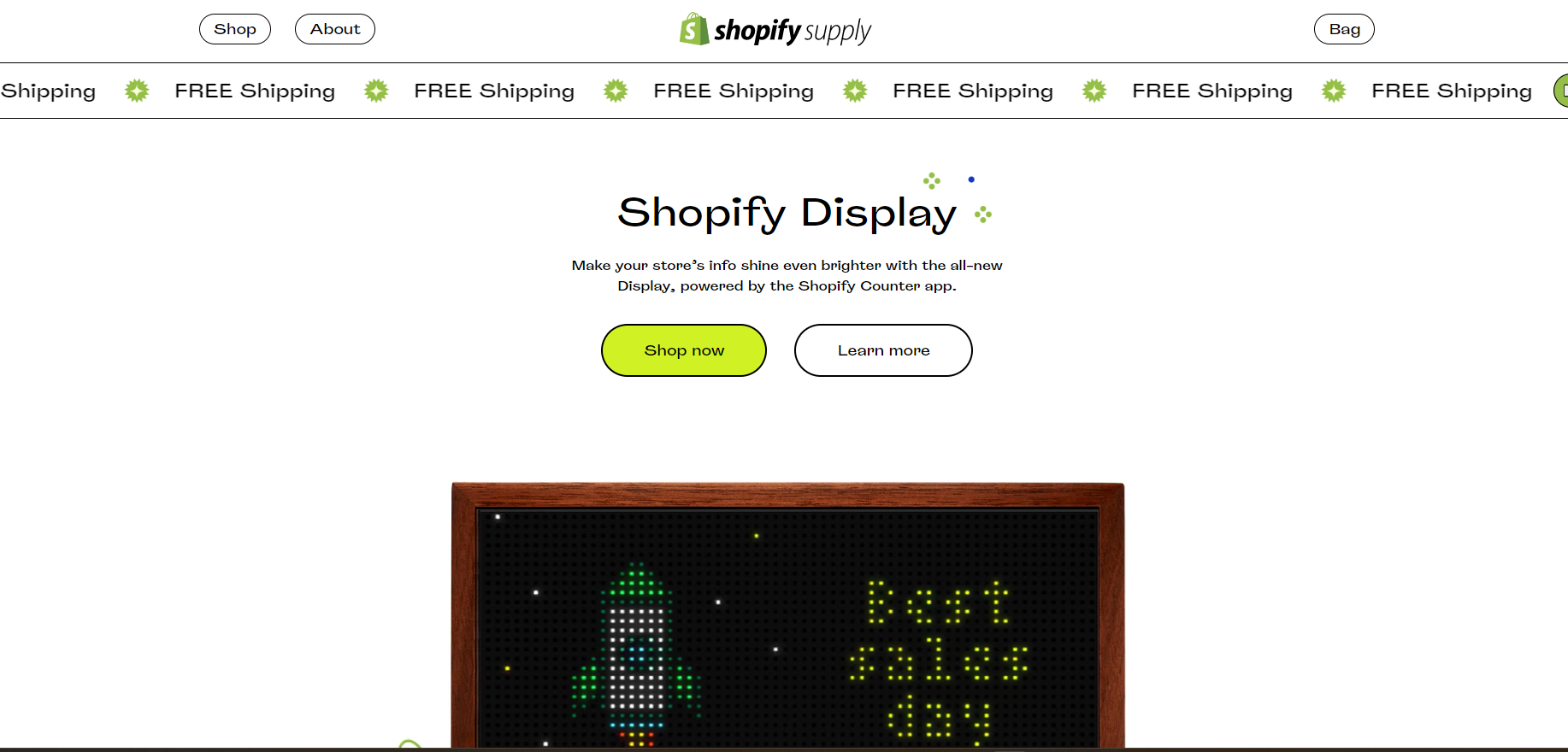 Shopify display sign on a storefront page with a bright green button and pixel-art LED panel below