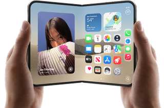 Hands holding a foldable smartphone with a home screen and a photo widget displayed.