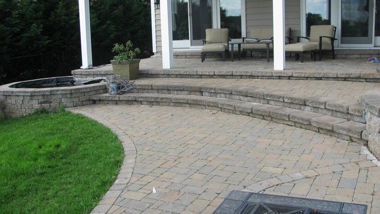 Expertly built outdoor patio with stone hardscaping in a Maryland backyard by J Gonzalez