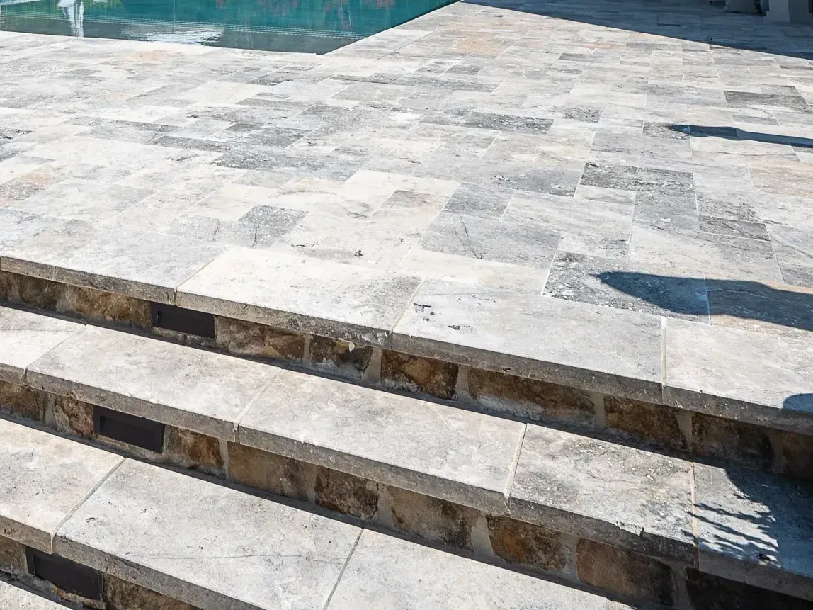 A set of stairs leading up to a swimming pool.