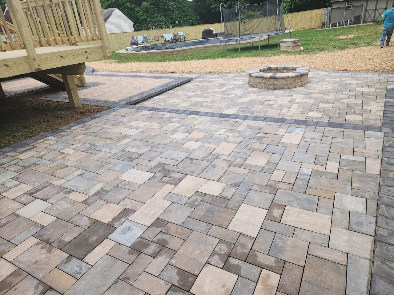 A patio with a fire pit in the middle of it