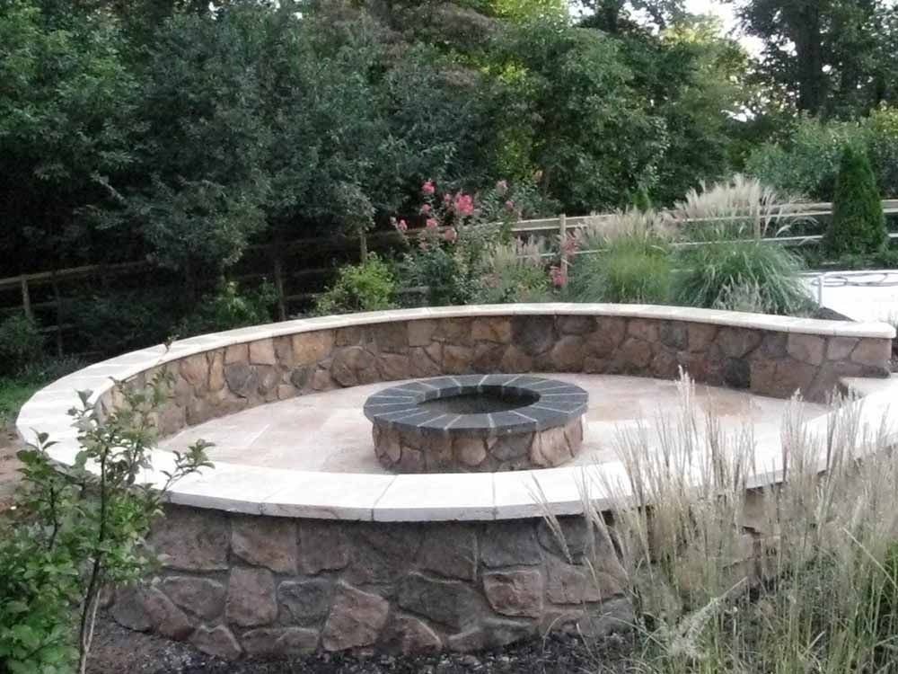 Wood Buring Outdoor Fire Place made with Natural Stone in the backyard of Maryland Home owner in Maryland