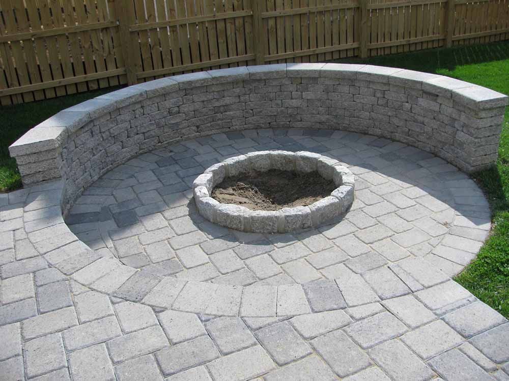 Stone Retaining Wall in Maryland with an In-ground Fireplace Installation by J Gonzalez Construction