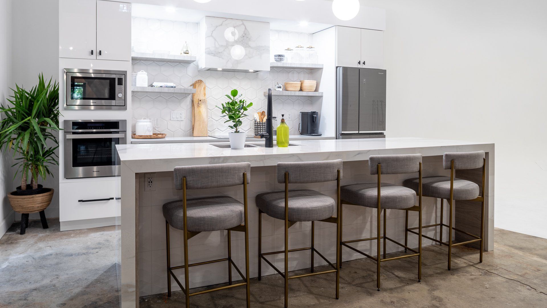 a kitchen with a large island and bar stools .