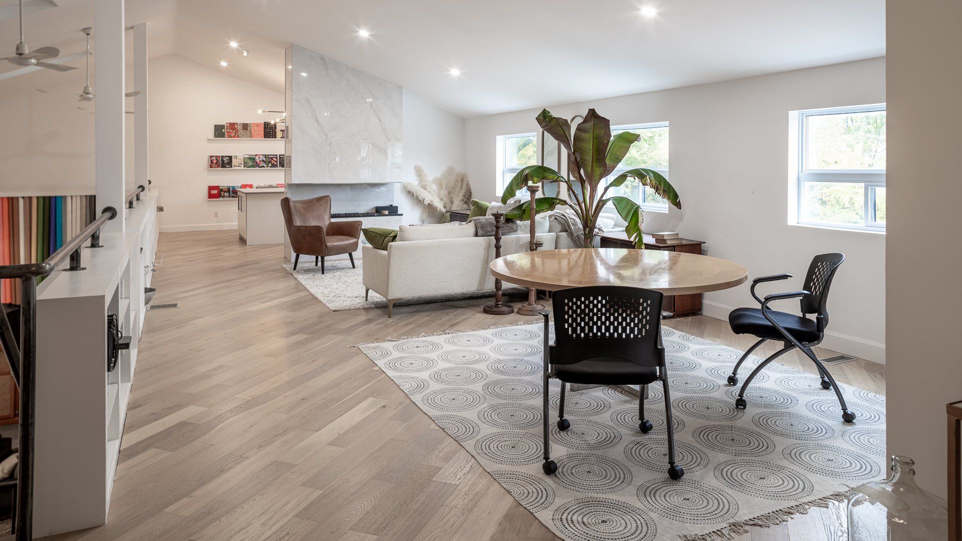 there is a table and chairs in the middle of the room .
