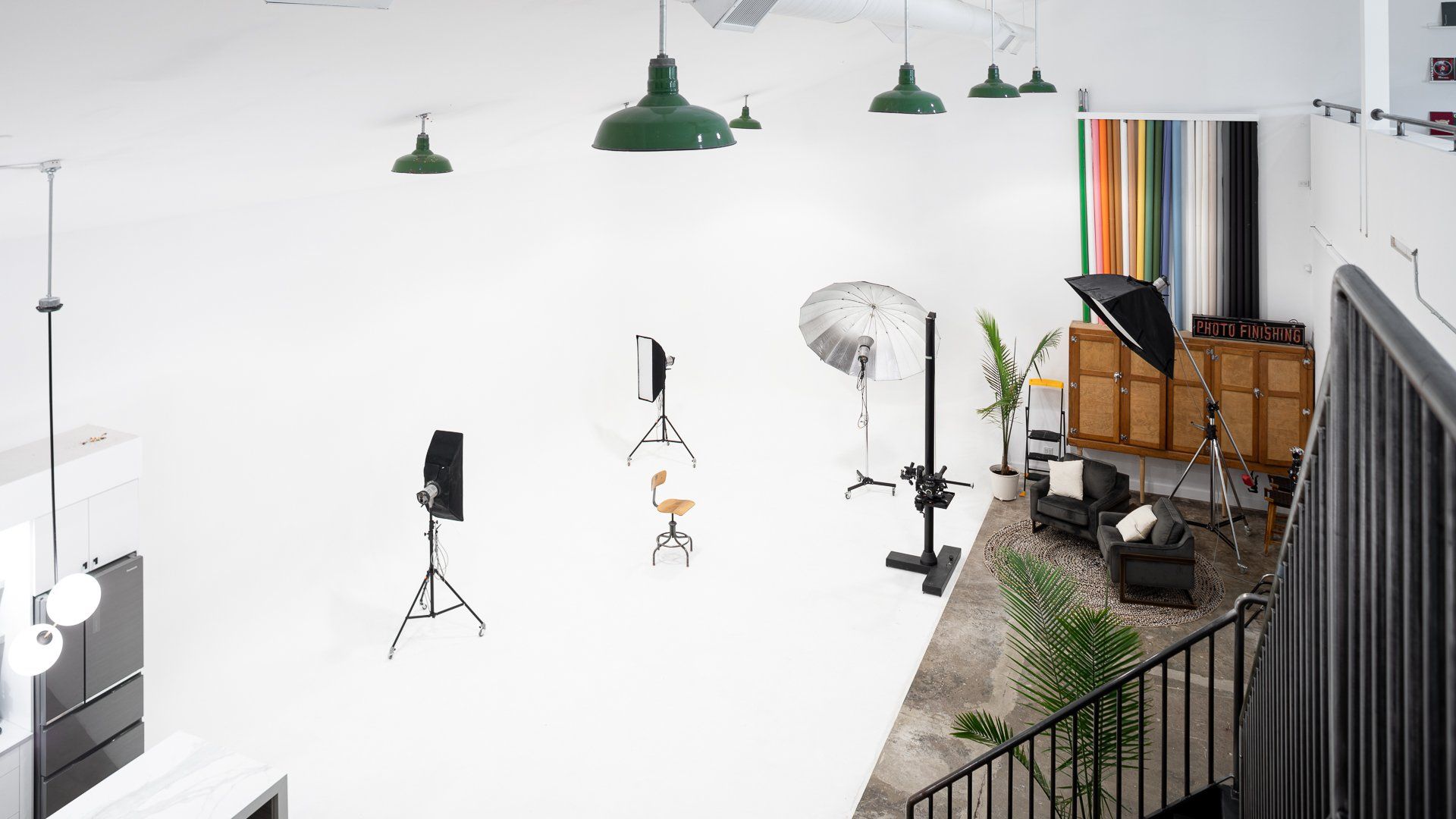 an aerial view of a large white room with a staircase leading up to it .
