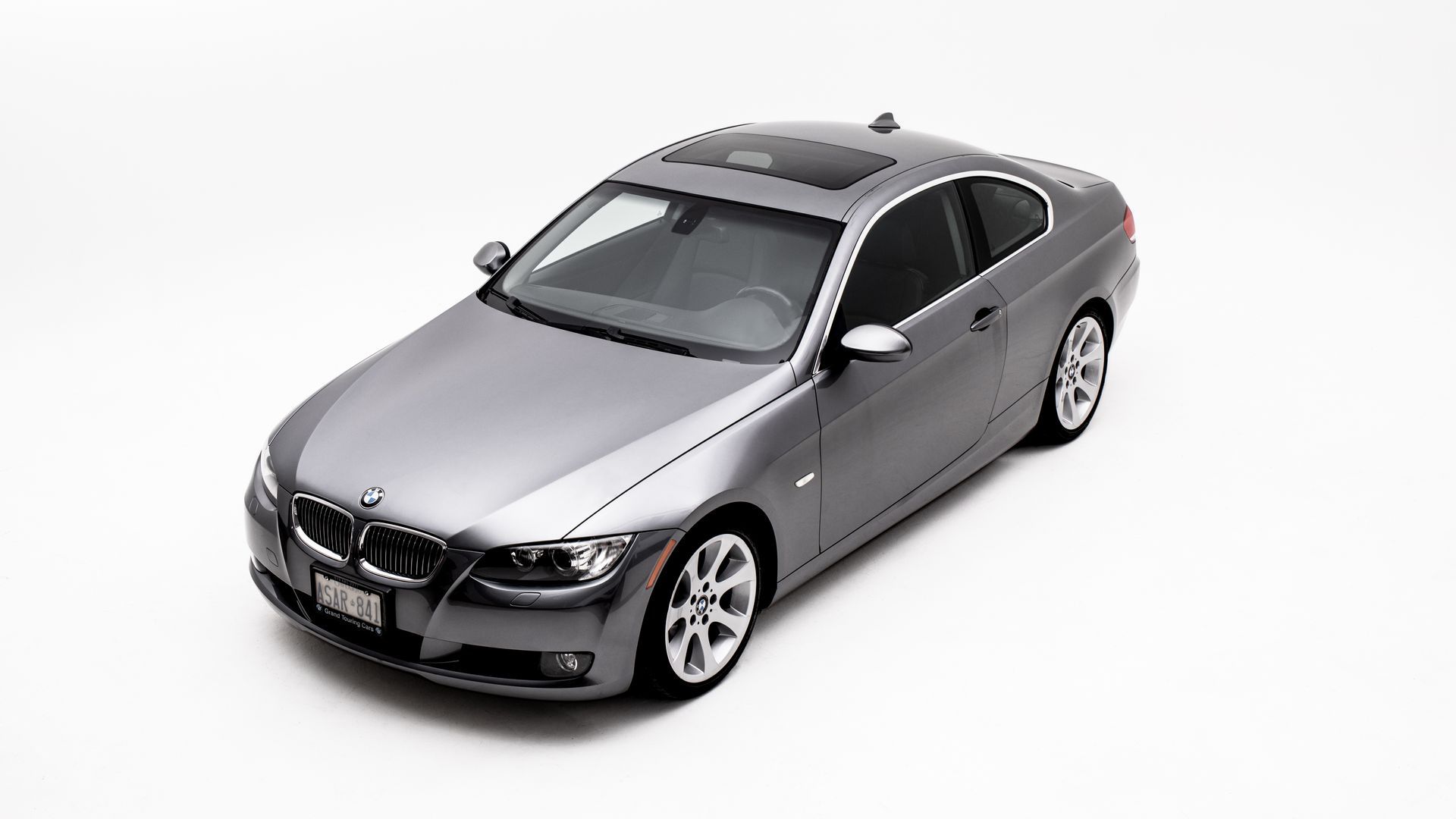 Gray BMW coupe, top-down view, on white background.