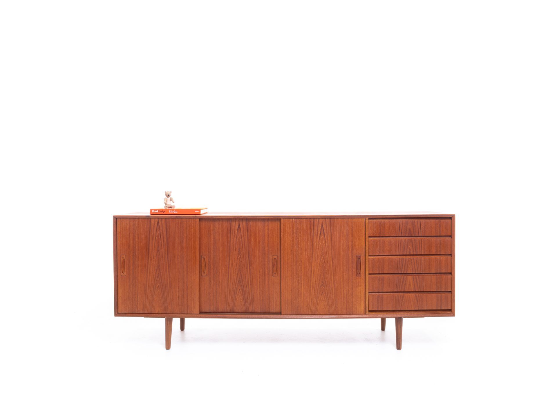 a long wooden cabinet with sliding doors and drawers on a white background .