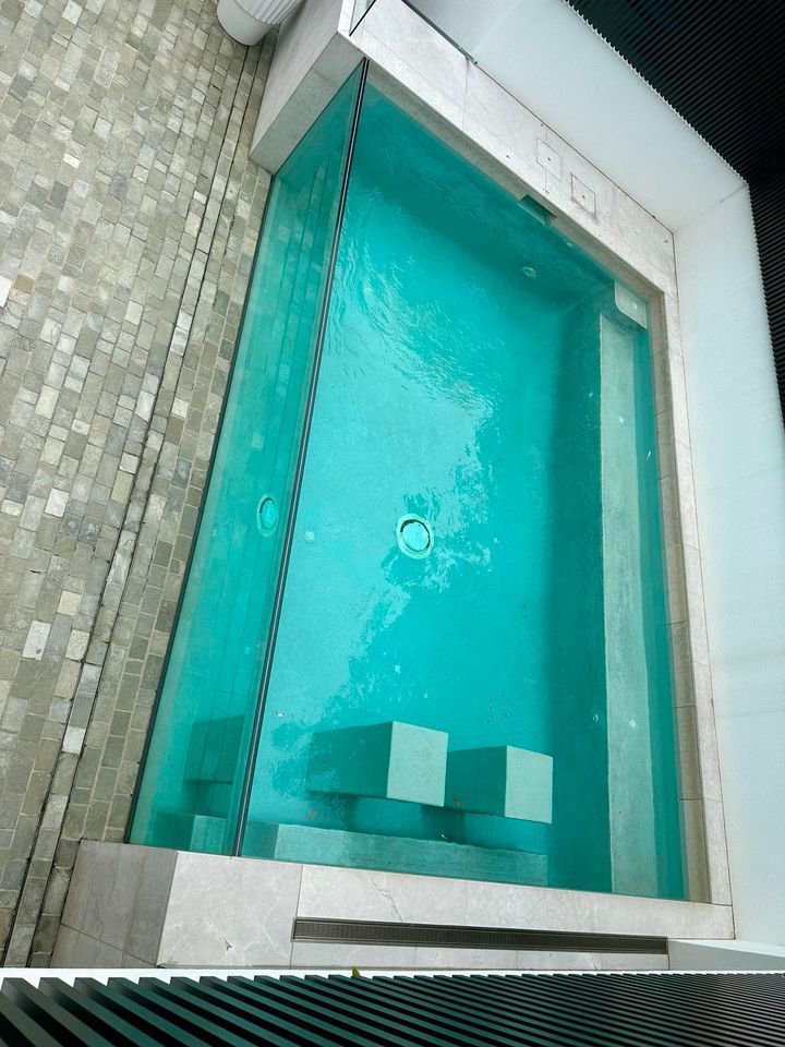 A Swimming Pool With A Clear Glass Surround — Glass Pool Windows Australia In Geelong, VIC
