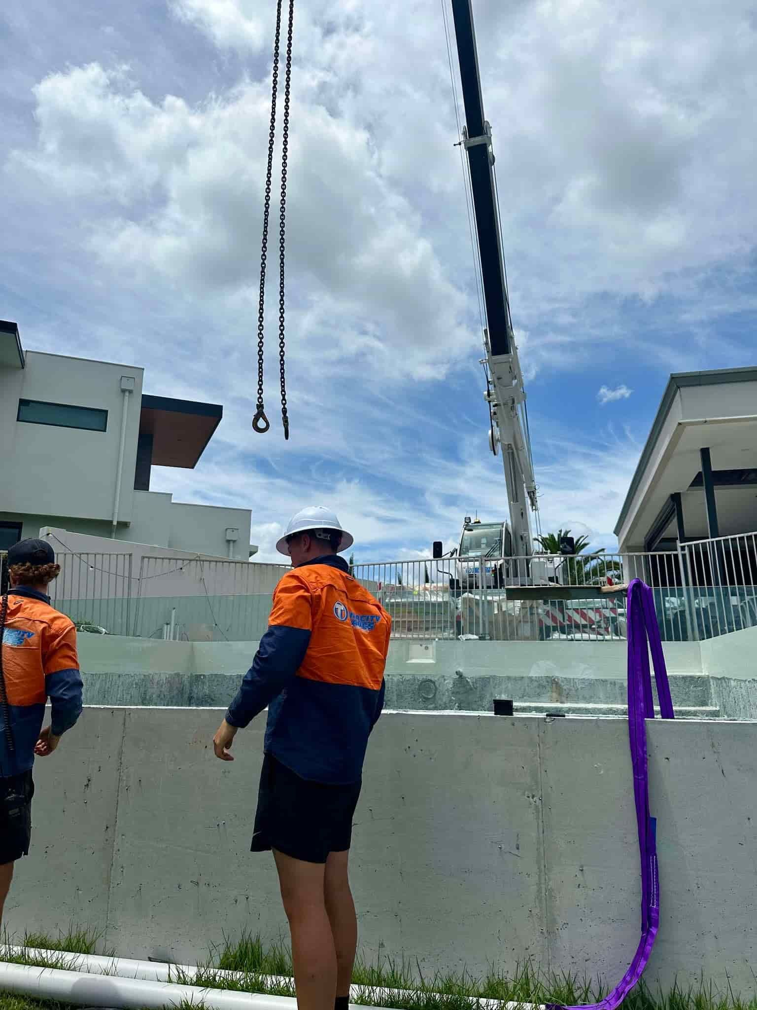 Construction Workers Operating a Crane on a Job Site — Glass Pool Windows Australia In Dee Why, NSW
