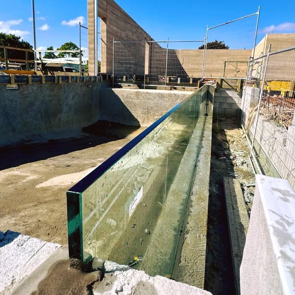 A Glass Railing Is Being Installed On A Construction Site — Glass Pool Windows Australia In Sunshine Coast, QLD