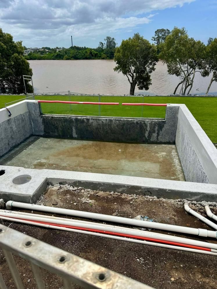 A Swimming Pool Is Being Built Next To A River — Glass Pool Windows Australia In Canberra, ACT