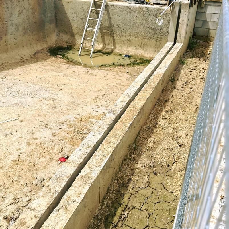 A Ladder Is Sitting On The Side Of A Concrete Wall — Glass Pool Windows Australia In Rockhampton, QLD