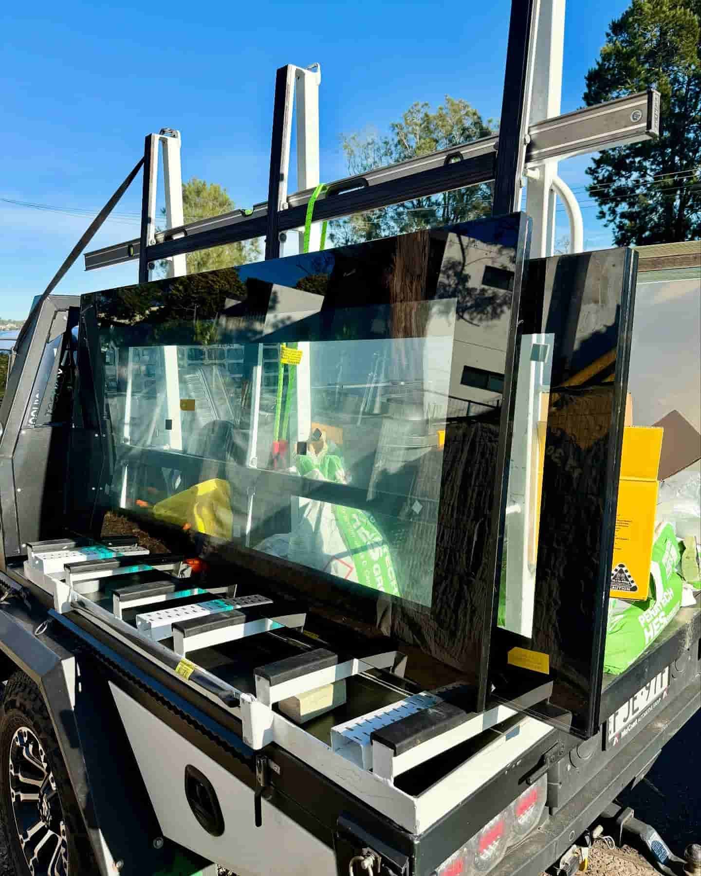 Large Sheets of Black Glass Secured on a Truck Bed — Glass Pool Windows Australia In Manly, NSW