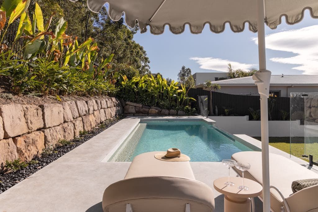 Poolside Scene With Lounge Chairs and Tables — Glass Pool Windows Australia In Bondi, NSW