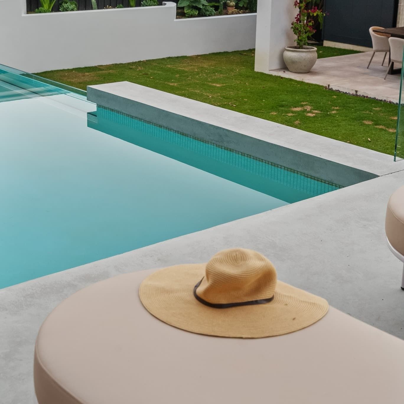 A Lounge Chair Next to a Pool — Glass Pool Windows Australia In Bondi, NSW