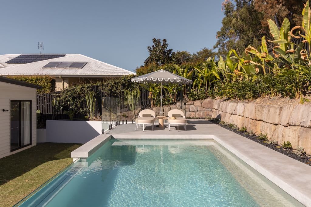 Pool Area With Lounge Chairs — Glass Pool Windows Australia In Broadbeach, QLD