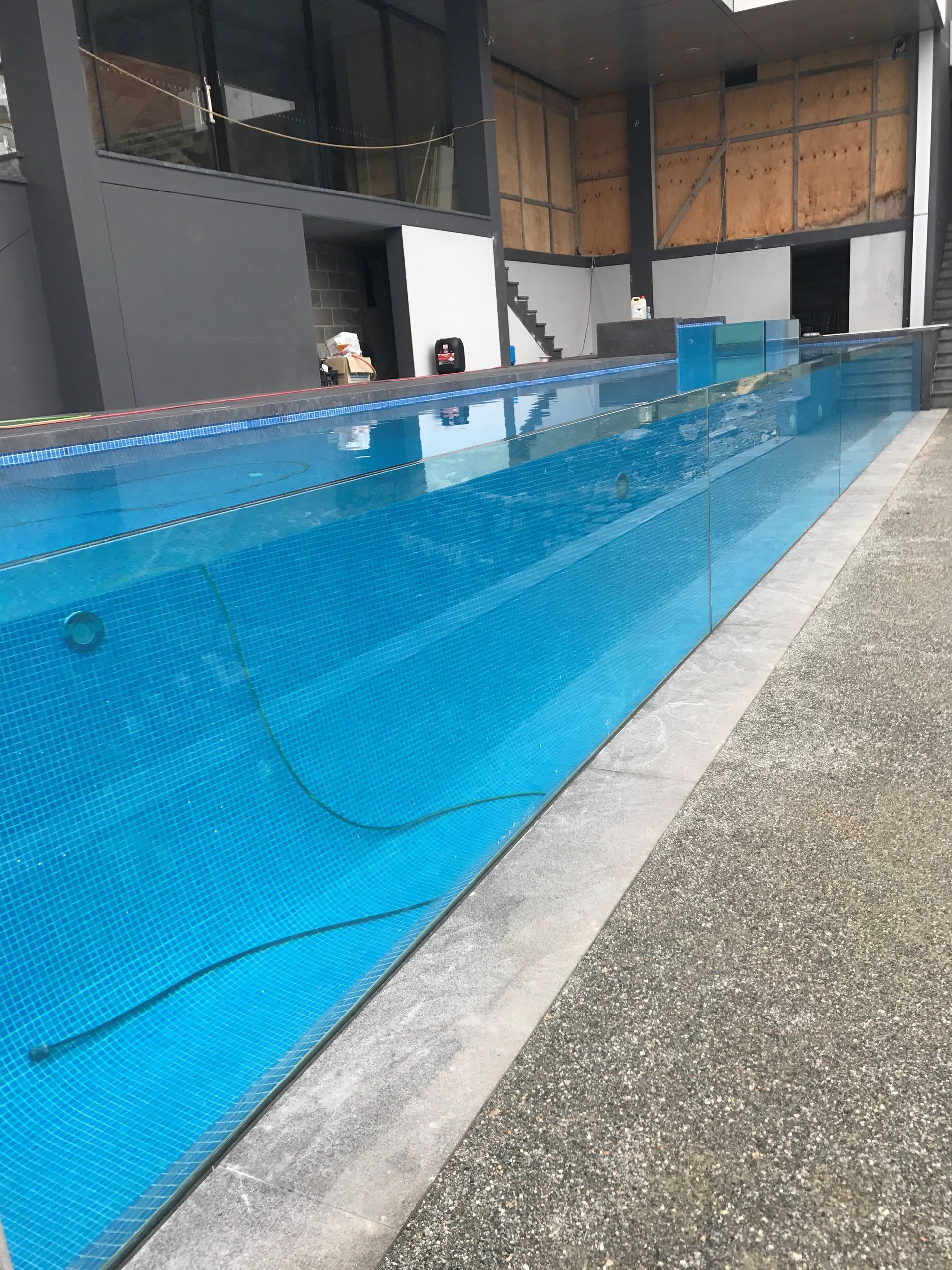 A Large Swimming Pool Is Being Built In A Building — Glass Pool Windows Australia In Old Bar, NSW