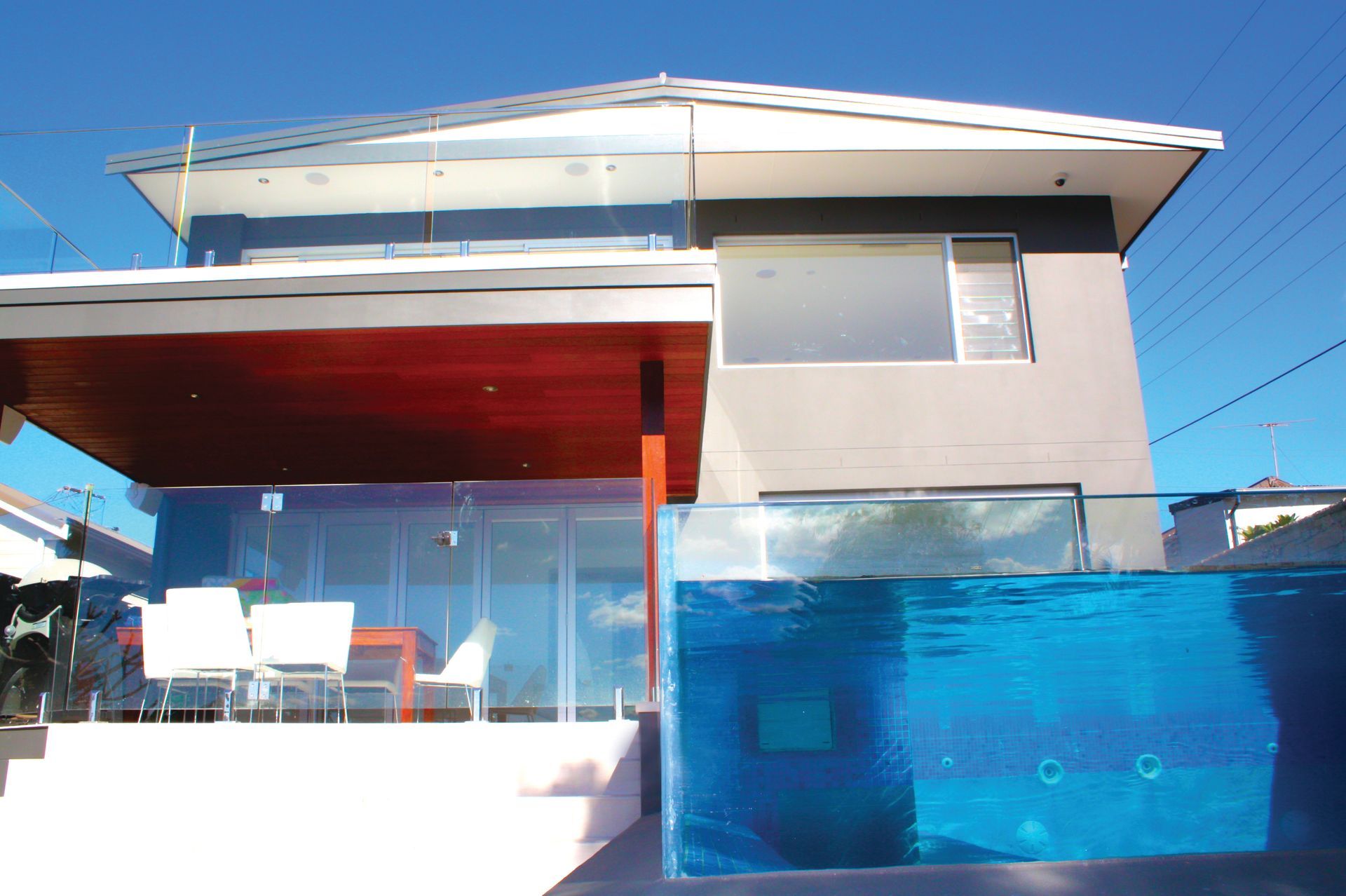 A House With A Swimming Pool In Front Of It — Glass Pool Windows Australia In Brisbane, QLD