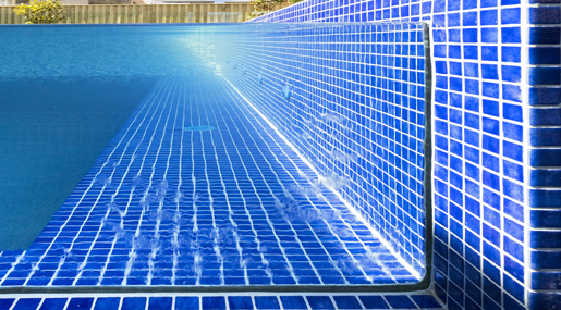 A Swimming Pool With Blue Tiles On The Walls And Floor — Glass Pool Windows Australia In Old Bar, NSW