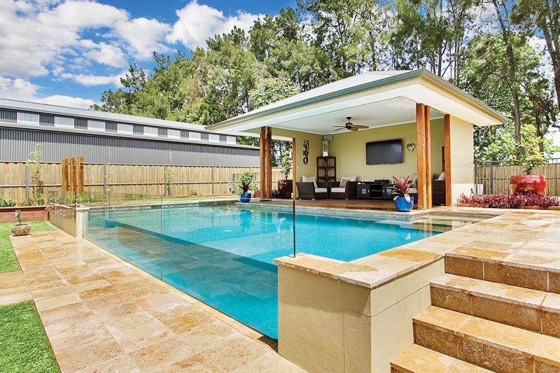 There Is A Large Swimming Pool In The Backyard Of A House — Glass Pool Windows Australia In Melbourne, VIC