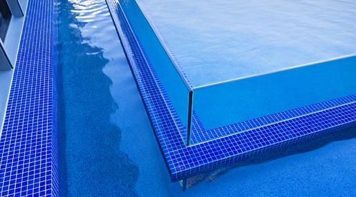 A Close Up Of A Swimming Pool With Blue Tiles And Steps — Glass Pool Windows Australia In Old Bar, NSW
