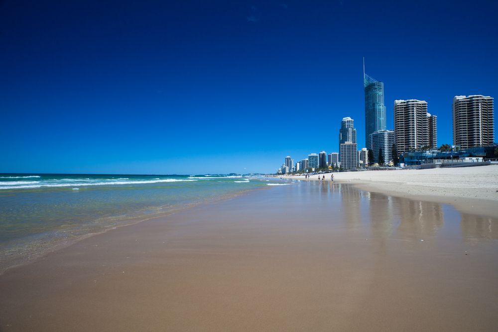 A Beach With A City Skyline In The Background — Glass Pool Windows Australia In Gold Coast, QLD
