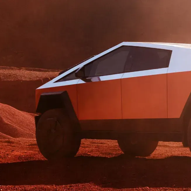Tesla Cybertruck on a Mars-like surface, with an orange and white color scheme. The angular vehicle is in a desolate, reddish landscape.