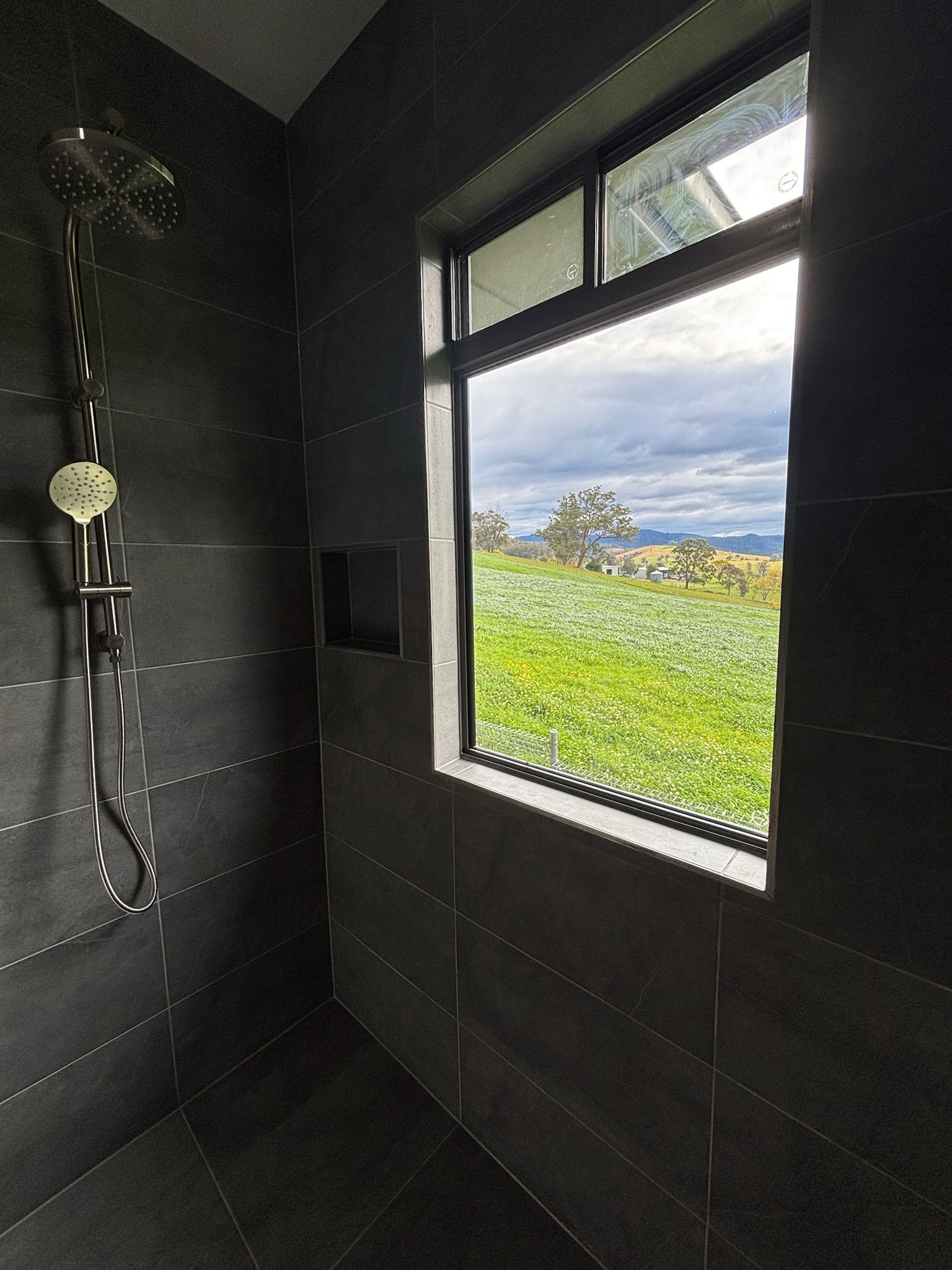 Dark Tiled Shower With a Window Overlooking — Edmonds Bathroom Renovations & Tiling In Thrumster, NSW