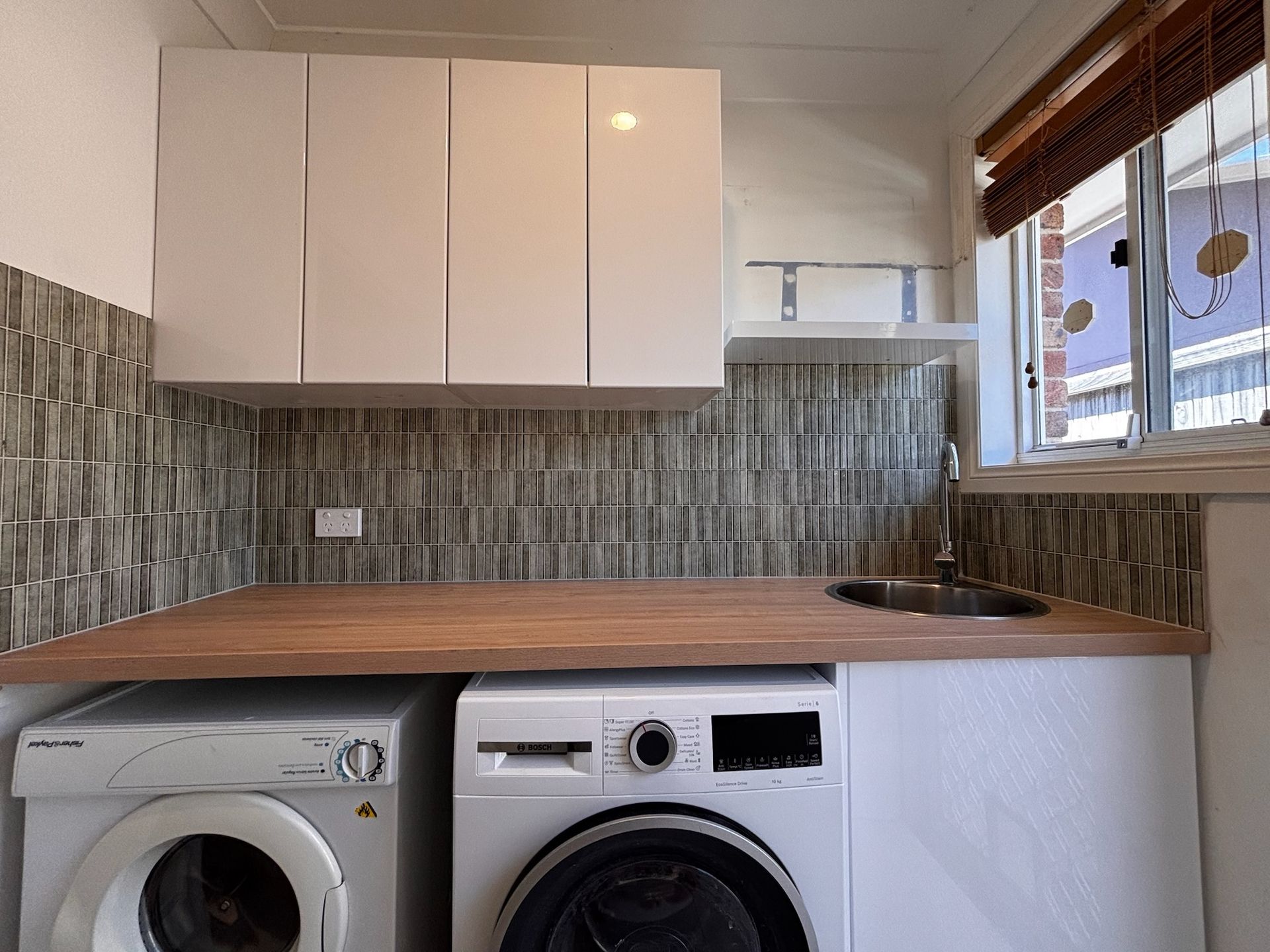 Laundry Room With White Cabinets, Wooden Countertop — Edmonds Bathroom Renovations & Tiling In Port Macquarie, NSW