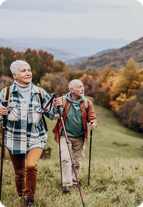 Older couple hiking and enjoying it.