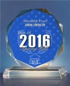 An octagon-shaped crystal award on a glass base, displaying 