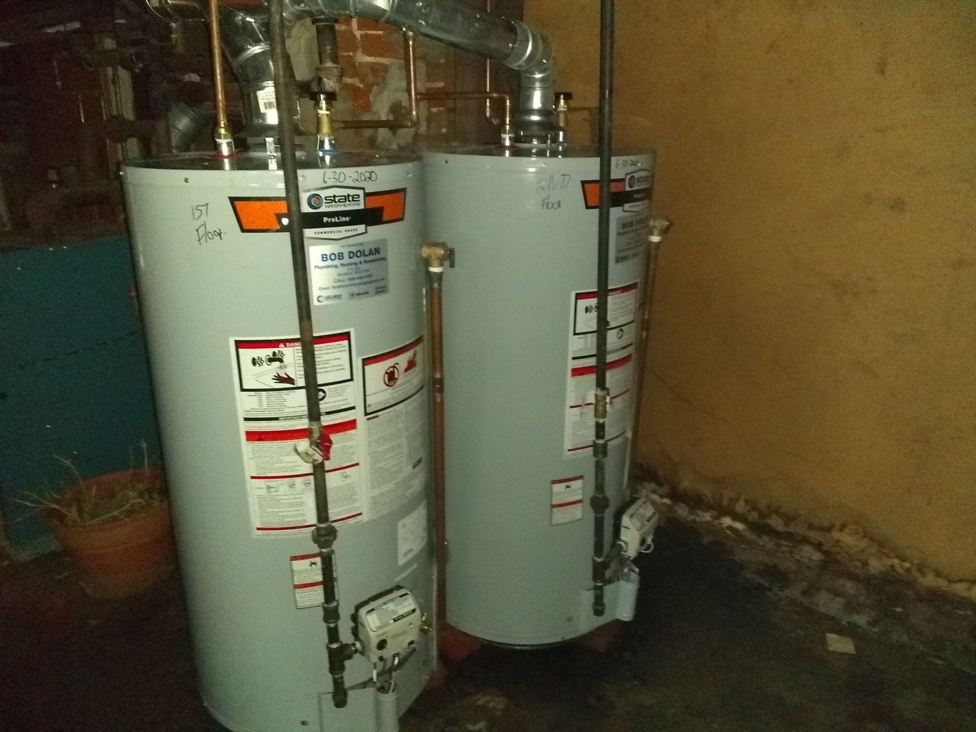 Person Fixing a Water Heater — Marlborough MA — Bob Dolan Plumbing, Heating & Remodeling Person Fixing a Water Heater — Marlborough MA — Bob Dolan Plumbing, Heating & Remodeling